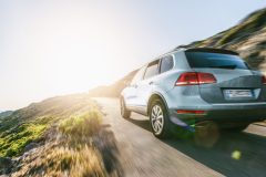 rental SUV car in spain mountain landscape road at sunset